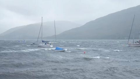 Yachts and fishing boats bob around in stormy seas on Loch Linnhe, western Scotland