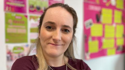 Woman with long hair and a purple top