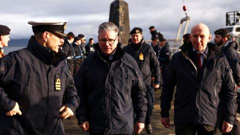 Starmer and Healey in military uniform with military members