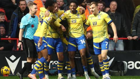 Colchester players celebrate Kyreece Lisbie's goal