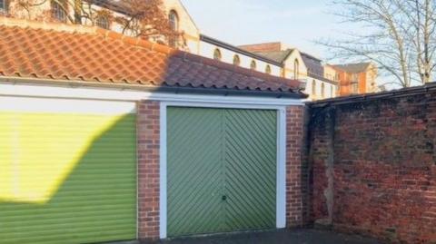 Garage with a green door