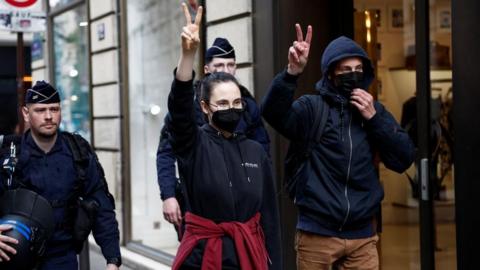 Protesters in support of Palestinians in Gaza are escorted away by police forces during the evacuation of the Sciences Po University in Paris, 3 May 2024