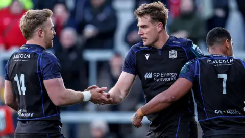 Glasgow players celebrate a try