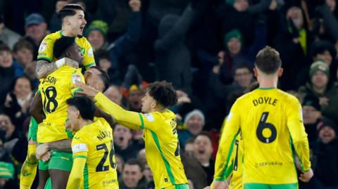 Amankwah Forson is lifted off the ground by Norwich team-mates after he scored against Coventry