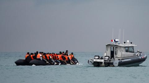 Migrants near the French coast, attempting to cross the Channel on an inflatable dinghy