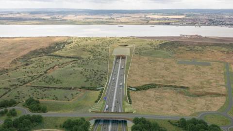 CGI image of a large road in the middle of grasslands which then goes beneath a river, running horizontal across the fields