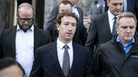 Zuckerberg walking next to other people