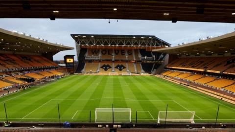 A view of an empty Molineux stadium and pitch taken from one of the stands behind one of the goals.