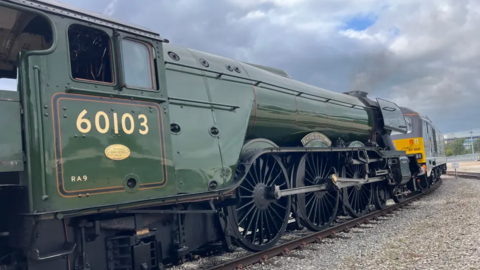 The Flying Scotsman is pictured on train tracks