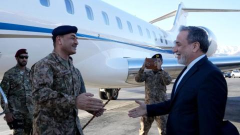 Pakistan's military chief, Asim Munir, greets Iran's foreign minister, Seyed Abbas Araghchi