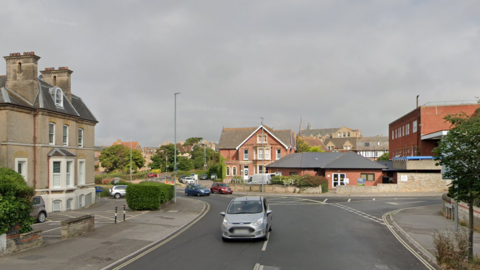 Google Street View of Dorchester Road in Weymouth - a one-way system with Victorian buildings in the middle.