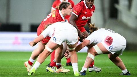 Gillian Boag being tackled by two England players during an international match for Canada