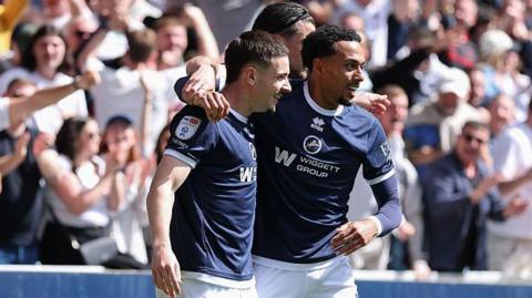 Camiel Neghli and Femi Azeez celebrate in front of the Millwall supporters