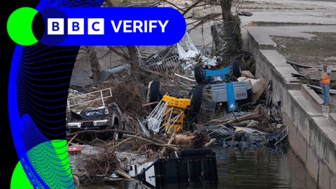 An image showing the flood in Texas. Cars and trees are submerged in water