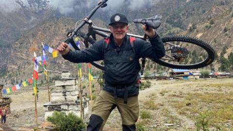 Neil Laughton with his bike in the Himalayas