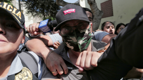 Police officers escort Nicanor Boluarte, brother of Peruvian President Dina Boluarte, as he leaves his home, after prosecutors detained him for allegedly being part of a group that trafficked influence