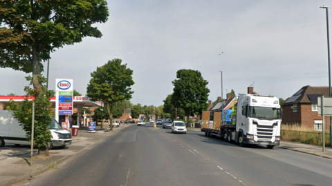 A view of the street with a petrol station by the roadside