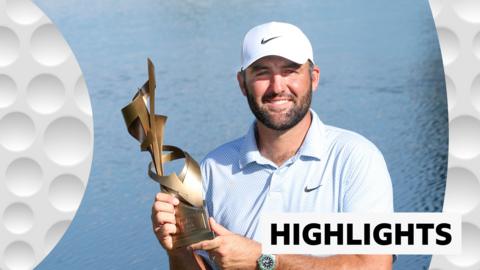 Scottie Scheffler holds up the trophy