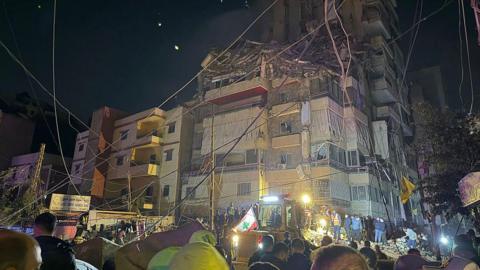 Emergency service workers outside a damaged building in Beirut 