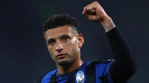 Ben Godfrey salutes the Atalanta fans after the team's Champions League win over Shakhtar Donetsk in Gelsenkirchen