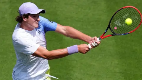 Joao Fonseca hits a backhand