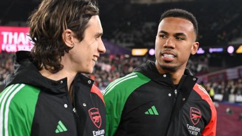 Gabriel of Arsenal speaks with team-mate Riccardo Calafiori