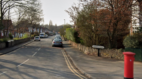 A residential street, with a sign for Brookvale Road and a red postbox in the foreground