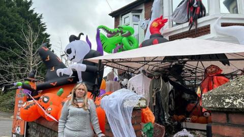 Claire Cox outside her Halloween house