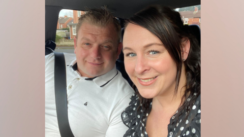 A man and woman sitting in a car