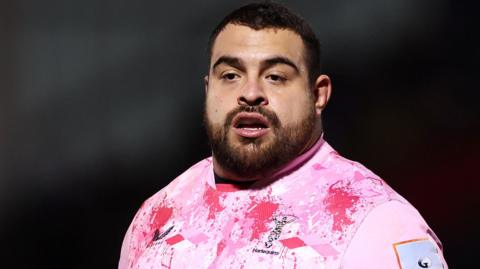 A head and shoulders close-up of Harlequins' Pedro Delgado, in a pink away jersey, during a match