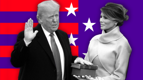 Donald Trump, dressed in a suit and tie, places his hand on a Bible his wife Melania Trump is holding. They are standing before a background of red stripes and white stars on a purple background