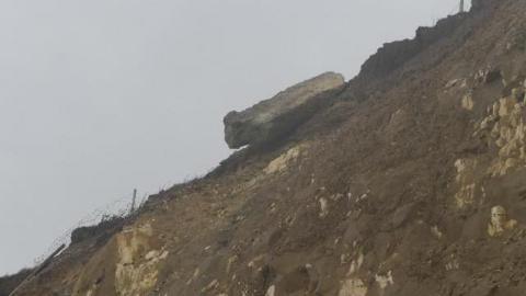 A large slab of concrete overhanging a cliff