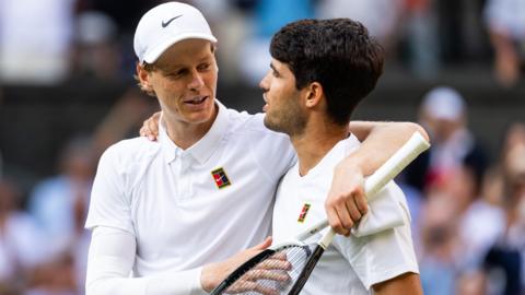 Jannik Sinner and Carlos Alcaraz hug at the net