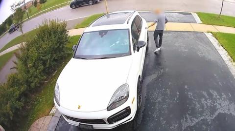 Man next to white Porsche