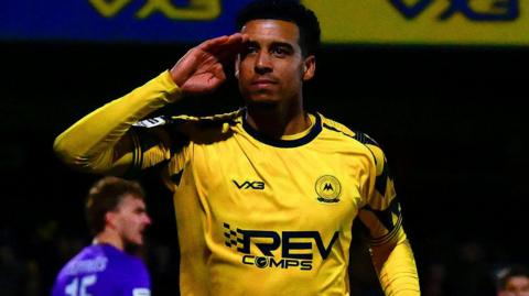 Louis Dennis salutes Torquay fans after scoring