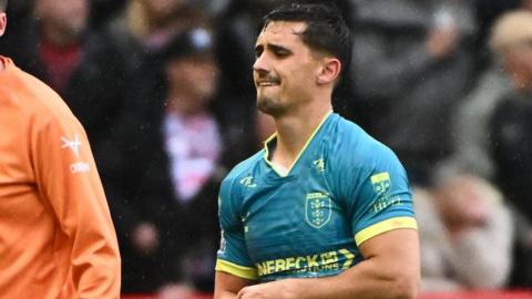 Arthur Mourgue wearing a green shirt goes off injured in Hull KR's win at Leigh
