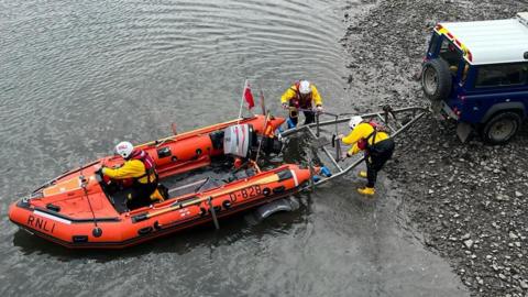 An aerial shot of the inshore boat at Seahouses being launched 