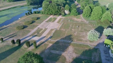 A drone shot of outlines in the parched grass