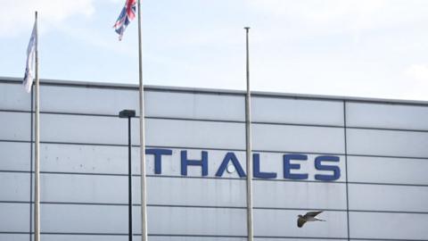 A photograph taken on March 19, 2024 shows the French aerospace, defence, transportation and security sectors multinational company Thales' plant with its logo on the building, in Belfast, Northern Ireland