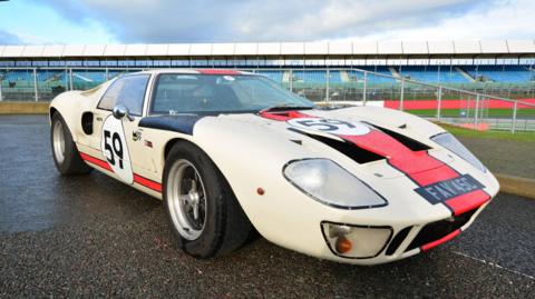 A white and red Ford GT40 in racing livery.