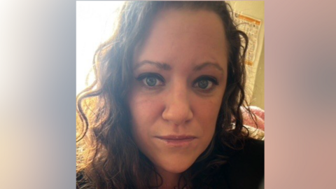 A close-up picture of Amanda's face. She is wearing a red and white striped top, beneath a darker top.