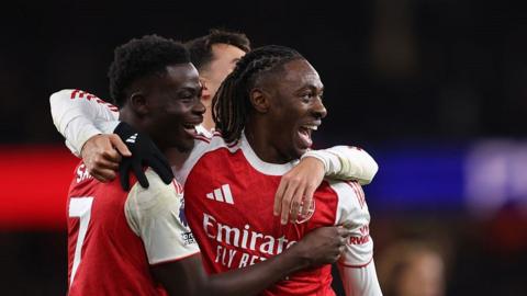 Eberechi Eze of Arsenal celebrates scoring a hat-trick goal to make it 4-1 with Bukayo Saka and Martin Zubimendi during the Premier League match between Arsenal and Tottenham Hotspur