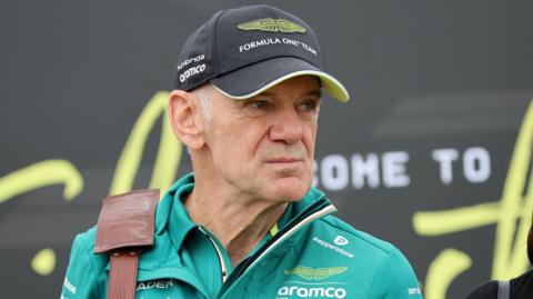 Aston Martin team boss pictured with a bag strap over his shoulder at the 2026 British Grand Prix