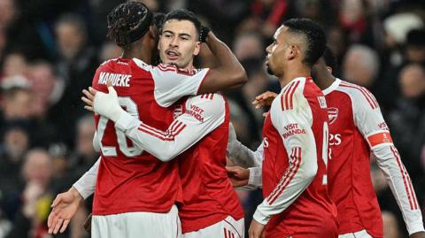 Arsenal players celebrate scoring against Wigan in the FA Cup