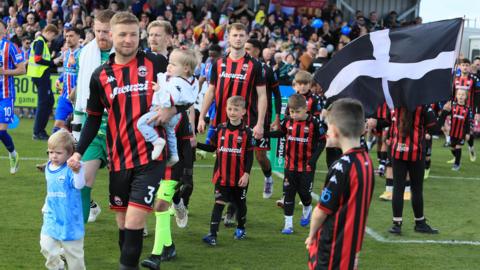 Truro City players walk out for final game of season.