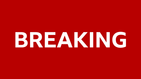 A breaking news story graphic. It is white text on a red background, saying breaking in capital letters.