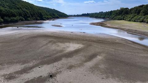 In this aerial view, low water levels reveal the reservoir bed at Lindley Wood Reservoir in Yorkshire after the driest spring in 132 years on June 17, 2025 in Otley, England. 