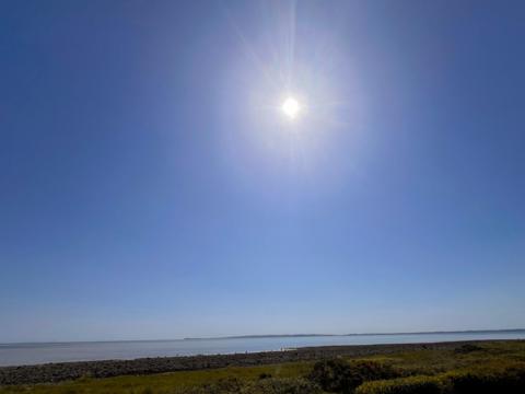 Sunny blue sky over a calm rocky coastline in Craignarget, Dumfries and Galloway