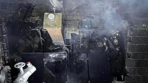 The damaged burned out roof in the aftermath of the fire