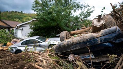 Storm-damaged vehicles are shown in the aftermath of Hurricane Helene on September 30, 2024 near Black Mountain, North Carolina